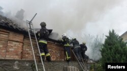 乌克兰哈尔科夫市一个住宅楼遭到俄军炮击后起火。(路透社)