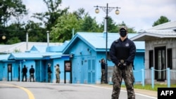资料照片:韩国士兵与联合国军司令部士兵守卫在分隔朝鲜半岛南北方的非军事区共同警备区内的军事分界线附近。(2022年10月4日)