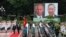 Ông Tô Lâm (phía trái trên thảm đỏ), và ông Putin, duyệt hàng quân danh dự tại Phủ Chủ Tịch tại Hà Nội, 20 tháng Sáu, 2024.