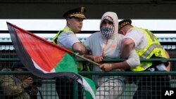 Police detain a protester during a demonstration outside the Democratic National Convention, Aug. 21, 2024, in Chicago.