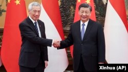 资料照片: 中国领导人习近平在北京会晤到访的新加坡总理李显龙(2023年3月31日)