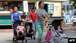 北京一家商场外的妇女和孩子(资料照:2014年10约18日)