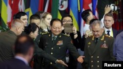中共中央军委副主席张又侠与俄罗斯国防部长绍伊古(右前)抵达北京出席香山论坛会场。(2023年10月30日)
