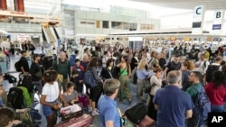强台风珊珊逼近日本东京地区,东京羽田机场的国际航站楼挤满了撤离的旅客。