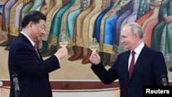 资料照片:俄罗斯总统普京和中国国家主席习近平在莫斯科克里姆林宫共同出席招待会。(2023年3月21日)