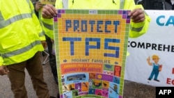 FILE - Demonstrators participate in the March for TPS (Temporary Protected Status) Justice during a protest in support of permanent residency, outside the White House in Washington, Feb. 12, 2019.
