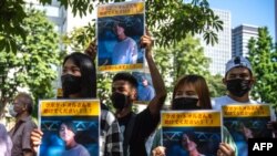 A group of activists hold placards of Japanese citizen Toru Kubota, who is detained in Myanmar, during a rally in front of the Ministry of Foreign Affairs in Tokyo on July 31, 2022.