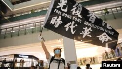 资料照片:一名示威者手持旗帜参加在香港的抗议活动。(2020年6月12日)