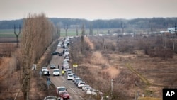 Cars wait to pick up family members and refugees fleeing the war in Ukraine, in Palanca, Moldova, March 2, 2022.