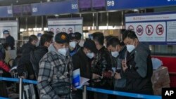 北京国际机场一个国际航班柜台排队的手持中国护照的乘客。(2022年12月29日)