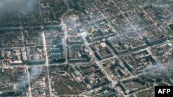 2022年3月21日拍摄和公布的Maxar卫星图像显示乌克兰马里乌波尔起火燃烧的建筑和剧院。
