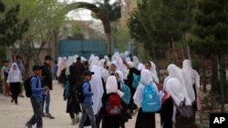 FILE - Afghan students leave school classes in a primary school in Kabul, Afghanistan on March 27, 2021.