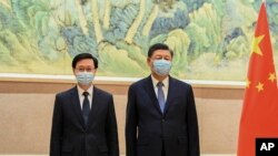 香港新当选的行政长官李家超在北京受到中国国家主席习近平的接见。(2022年5月30日)