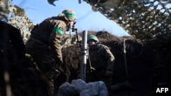 A Ukrainian serviceman gets ready to fire with a mortar from a position not far from Bakhmut, Donetsk region on Jan. 27, 2023, amid Russian invasion of Ukraine.