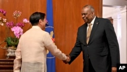 U.S. Secretary of Defense Lloyd James Austin III shake hands with Philippine President Ferdinand Marcos Jr. during a courtesy call at the Malacanang Palace in Manila, Feb. 2, 2023.