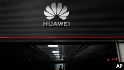 A technician stands at the entrance to a Huawei 5G data server center in Guangzhou, in southern China's Guangdong province on Sept. 26, 2021.