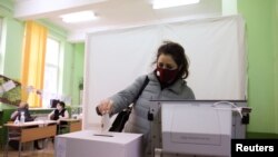 FILE - A woman votes in a polling station during parliamentary elections in Sofia, Bulgaria, Apr. 4, 2021.