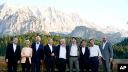 Members of the Group of Seven, including European Union leaders, pose for a photo at Schloss Elmau, following dinner, in Elmau, Germany, June 26, 2022.