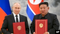 资料照片:俄罗斯总统弗拉基米尔·普京和朝鲜领导人金正恩在平壤举行的新伙伴关系签署仪式上合影。(2024年6月19日)