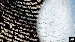 FILE - Names of the victims during the revealing of the National Monument for the MH17 in Vijfhuizen, The Netherlands, July 17, 2017.