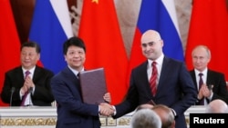 资料照:华为轮值董事长郭平2019年6月5日在中俄领导人习近平和普京的见证下代表华为与俄罗斯签下5G合同。