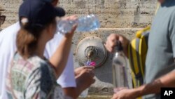 人们在梵蒂冈圣彼得广场的喷泉前排队。(资料照片:2024年8月11日)