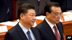 资料照:中国国家主席习近平与总理李克强在北京人大会堂出席全国人大会议闭幕式。(2019年3月15日)