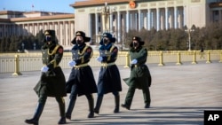 几名戴着口罩的中国武警士兵在北京天安门广场列队行走。(2020年2月4日)