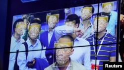 资料图片:人们在深圳一个公安科技产品展览会上体验人脸识别技术。