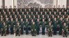 In this photo released by Xinhua News Agency, Chinese President Xi Jinping poses for photos with military personnel of the Chinese People's Liberation Army garrison stationed in the Macao Special Administrative Region in southern China, Dec. 20, 2024. (Li Gang/Xinhua via AP)