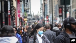 曼哈顿中城街道上一个戴口罩的妇女(3月3号)。