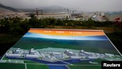 资料照:正在建设中的广东省台山核电站和建成后的效果图。(2013年10月17日)