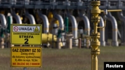 FILE - Warning signs are posted in front of a gas compressor station, a part of the Polish section of the Yamal pipeline that links Russia with western Europe and is owned in part by Gazprom, in Gabinek near Wloclawek, Poland, May 23, 2022.