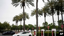 资料照片:2023年6月9日,特斯拉电动汽车在加利福尼亚州阿纳海姆的一个充电站充电。(美联社照片)