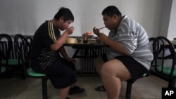 资料照:天津一家减肥医院的肥胖病人在吃午饭。(2008年7月24日)