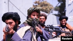 Taliban forces stand guard in front of Hamid Karzai International Airport in Kabul, Afghanistan, September 2, 2021.