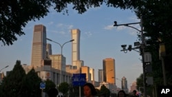 资料图片:2023年8月14日,在北京的高峰时间,人们走在中央商务区附近。(美联社)