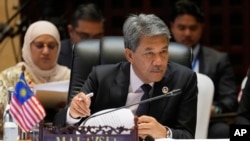 အာဆီယံအစည်းအဝေးတခုမှာတွေ့ရတဲ့ မလေးရှားနိုင်ငံခြားရေးဝန်ကြီး Mohamad Hasan