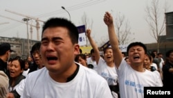 失踪马航班机乘客亲属在马来西亚驻北京大使馆外抗议游行。(2014年3月25日)