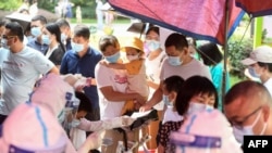 中国湖北武汉市民排队接受新冠病毒核酸检测。(2021年8月3日)