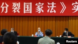 中国全国人大委员长栗战书(右)中央军委副主席许其亮(中)在北京出席“反分裂国家法”会议。(2020年5月29日)