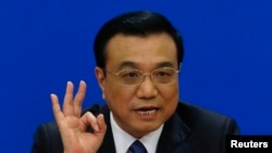 中国总理李克强在全国人大会议闭幕后在北京的人民大会堂举行记者会。(2014年3月13日)