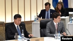 资料照:中国领导人习近平与加拿大总理特鲁多在日本大阪举行的G20峰会上。(2019年6月29日)