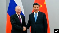 资料照:中国领导人习近平与俄罗斯总统普京在巴西出席金砖国家峰会期间举行会晤。(2019年11月12日)
