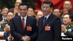 2013年3月15日在中国人大会议上,中国主席习近平和新总理李克强握手