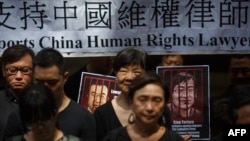 资料照:香港民众手举当时被中国政府监禁的维权律师的画像表达对中国人权律师的支持。(2017年7月9日)