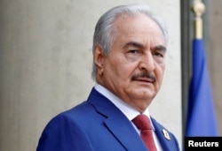 FILE PHOTO: Khalifa Haftar, the military commander who dominates eastern Libya, arrives to attend an international conference on Libya in Paris, May 29, 2018.