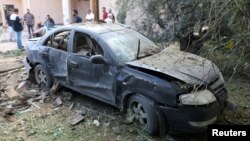 A damaged car is seen during clashes between rival factions in Tripoli, Libya, Aug. 30, 2018.