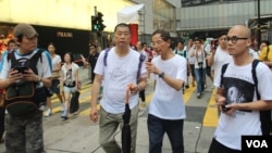 苹果日报老板黎智英(持伞)与大律师李柱铭参加13年七一游行(美国之音图片/海彦拍摄)