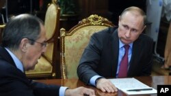 FILE - Russian President Vladimir Putin, right, listens to Russian Foreign Minister Sergey Lavrov during their meeting in the Kremlin in Moscow, Russia, March 14, 2016.
